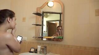 A mature woman with big tits plays with her hairy pussy in the morning