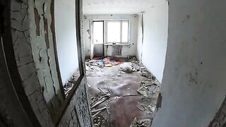Girl shows her big boobs while walking around a horrible house