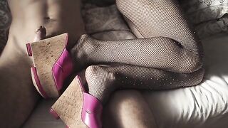 A girl in sexy high heels and pantyhose is teasing with her feet in a seductive video