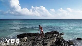 A sexy girl is masturbating on a public naked beach