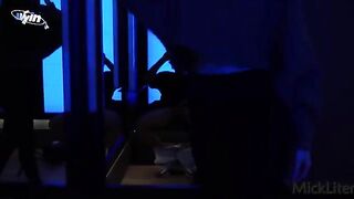 A girl is trying on clothes in the fitting room, while a guy is shooting her