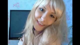 A blonde with small boobs caresses her smooth pussy