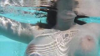 A naughty girl masturbates with a dildo in the swimming pool