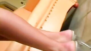 A nice woman masturbating on a leather chair