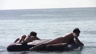 A girl with tan skin is completely naked on the beach