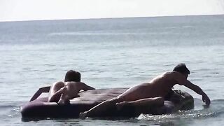 A girl with tan skin is completely naked on the beach