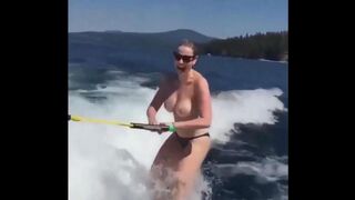 Girl in swimsuits skiing on the water surface without any support
