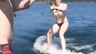 Girl in swimsuits skiing on the water surface without any support