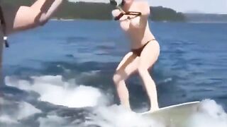 Girl in swimsuits skiing on the water surface without any support