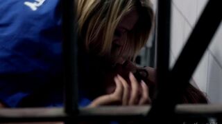 Two girls licking each other in the prison cell