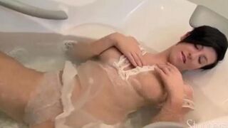 Lonely brunette woman caresses her pussy under the shower stream