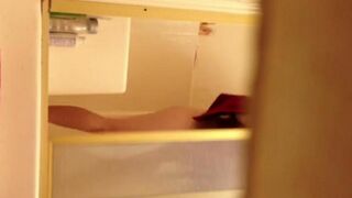 A girl takes a shower and is secretly filmed by a hidden camera