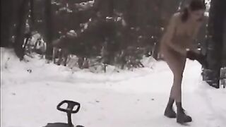 Nude girls are having fun with snowballs on the street during the winter