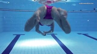 A hot and sexy girl is swimming naked in the pool