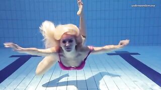 A hot and sexy girl is swimming naked in the pool