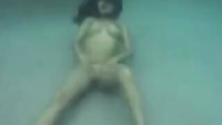 Sex in the ocean with a busty brunette beauty and a flirty ending