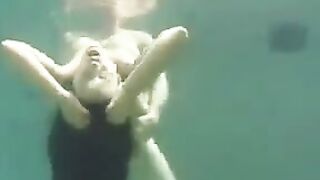 Sex in the ocean with a busty brunette beauty and a flirty ending