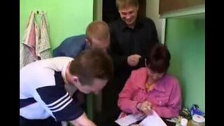 A Russian mom is having fun with three guys in the kitchen