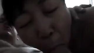 An adult Chinese woman practices her blowjob skills on him in a steamy scene