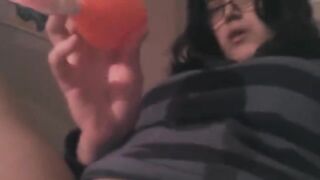 A girl plays with a vibrator to achieve clitoral stimulation