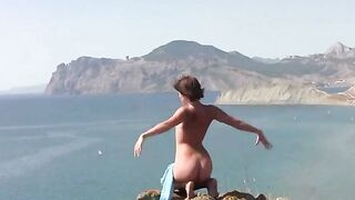 A natural beauty poses naked on the beautiful beach