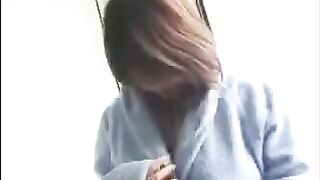 A fat Korean virgin with big boobs plays with her tits