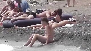 Nudist couple have fun on the beach in a naughty way
