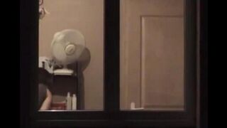 The guy looks at himself in the mirror completely naked