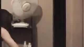 The guy looks at himself in the mirror completely naked