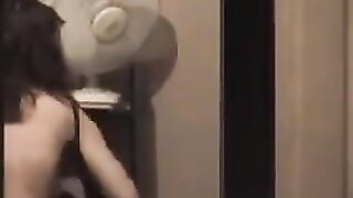 The guy looks at himself in the mirror completely naked
