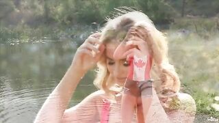 A blondie wanking her pussy by the lake
