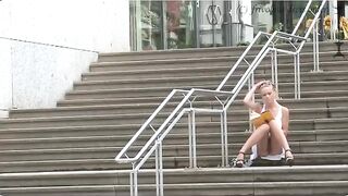 Girl without panties walks along the street and shows her ass