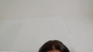 A cumshot on the face of a girl with beautiful breasts