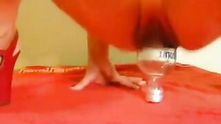 Fisting with a large dildo and a bottle for intense solo pleasure