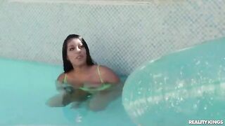 A hot girl has swimming lessons in the pool wearing a bikini