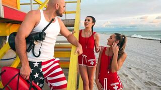 Two young lifeguards are having fun with a mature girl