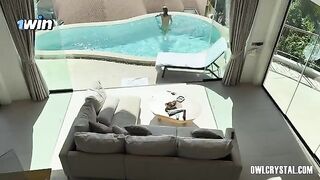 A girl is smoking a joint and getting wet in the pool