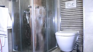 A girl has sex with her boyfriend in the shower, showcasing passion