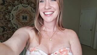 A woman with big tits is massaging herself with shimmering oil
