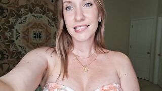 A woman with big tits is massaging herself with shimmering oil